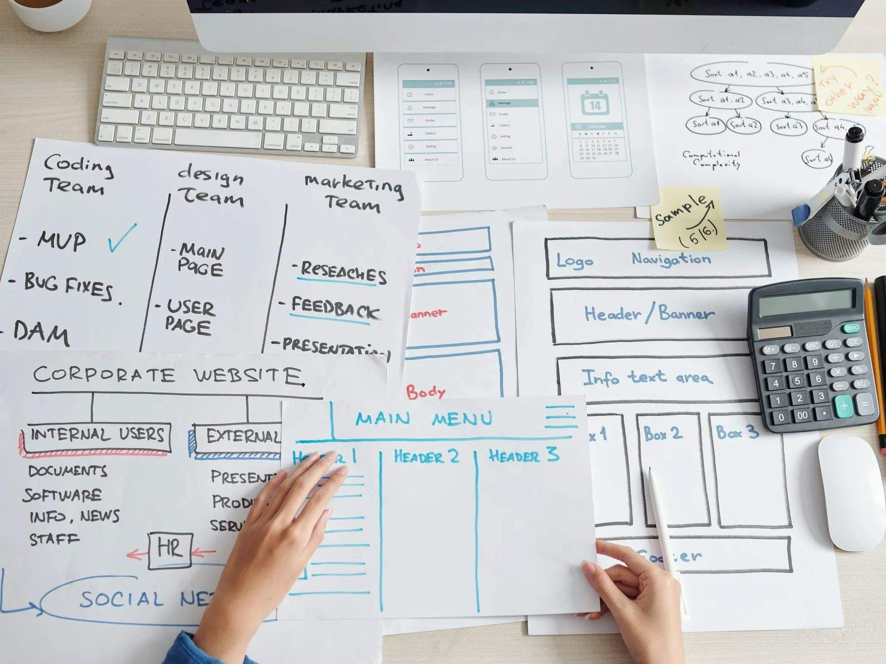 A top-down view of a desk with a project plan and flowcharts, representing the strategic planning phase.