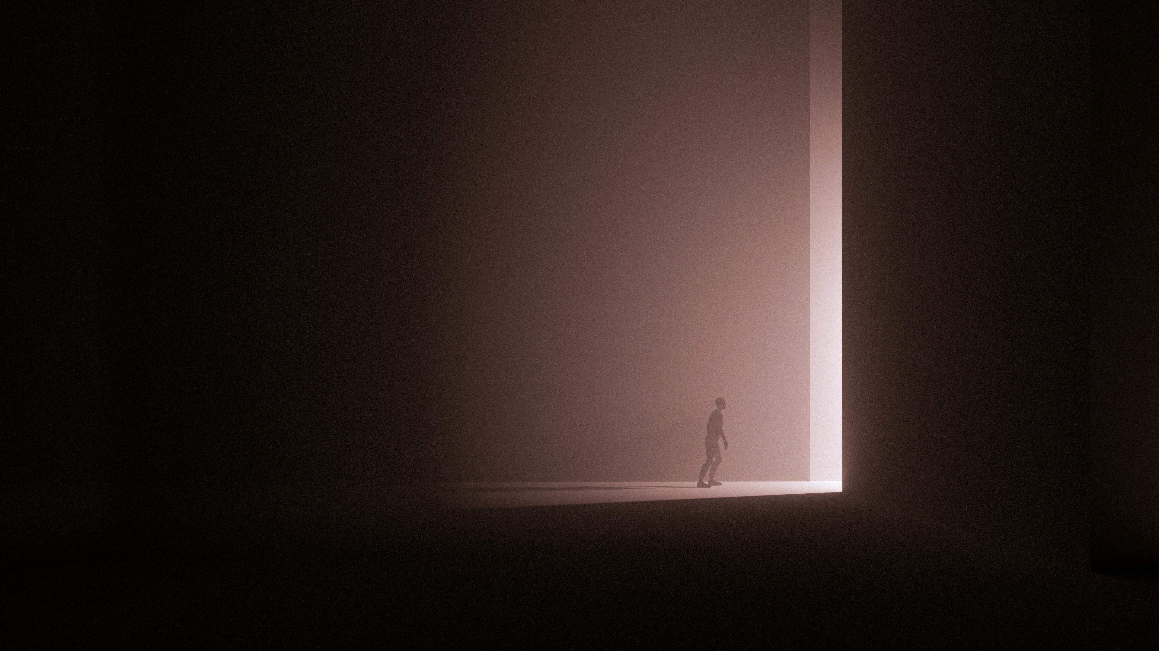 Person walking through door in darkness.