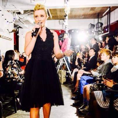 Me walking a runway and singing at a Ted Baker gig in Hong Kong, with very blonde hair and a black dress.