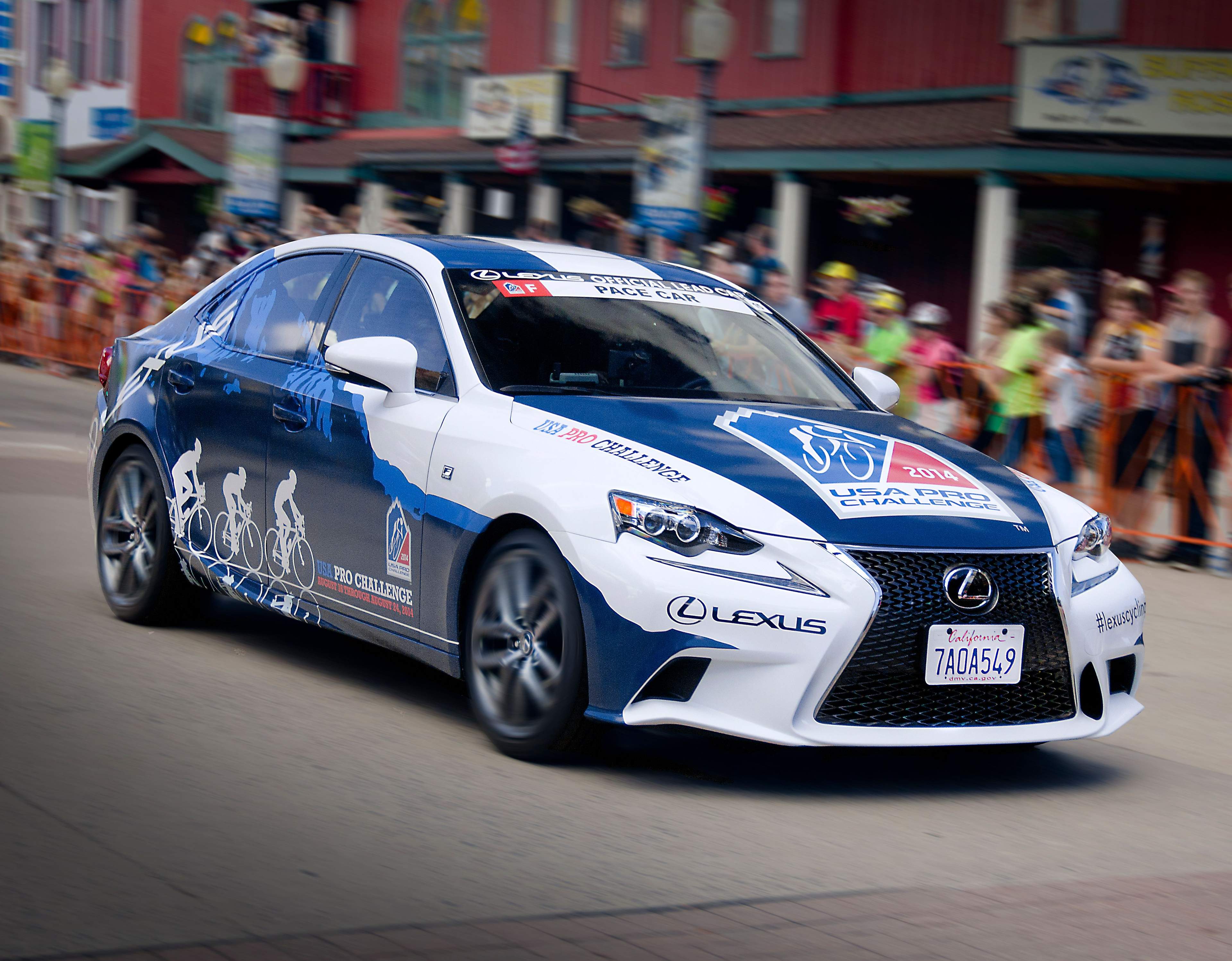 Lexus IS F-Sport pace car closely follower by the USA Pro Challenge bike racers.