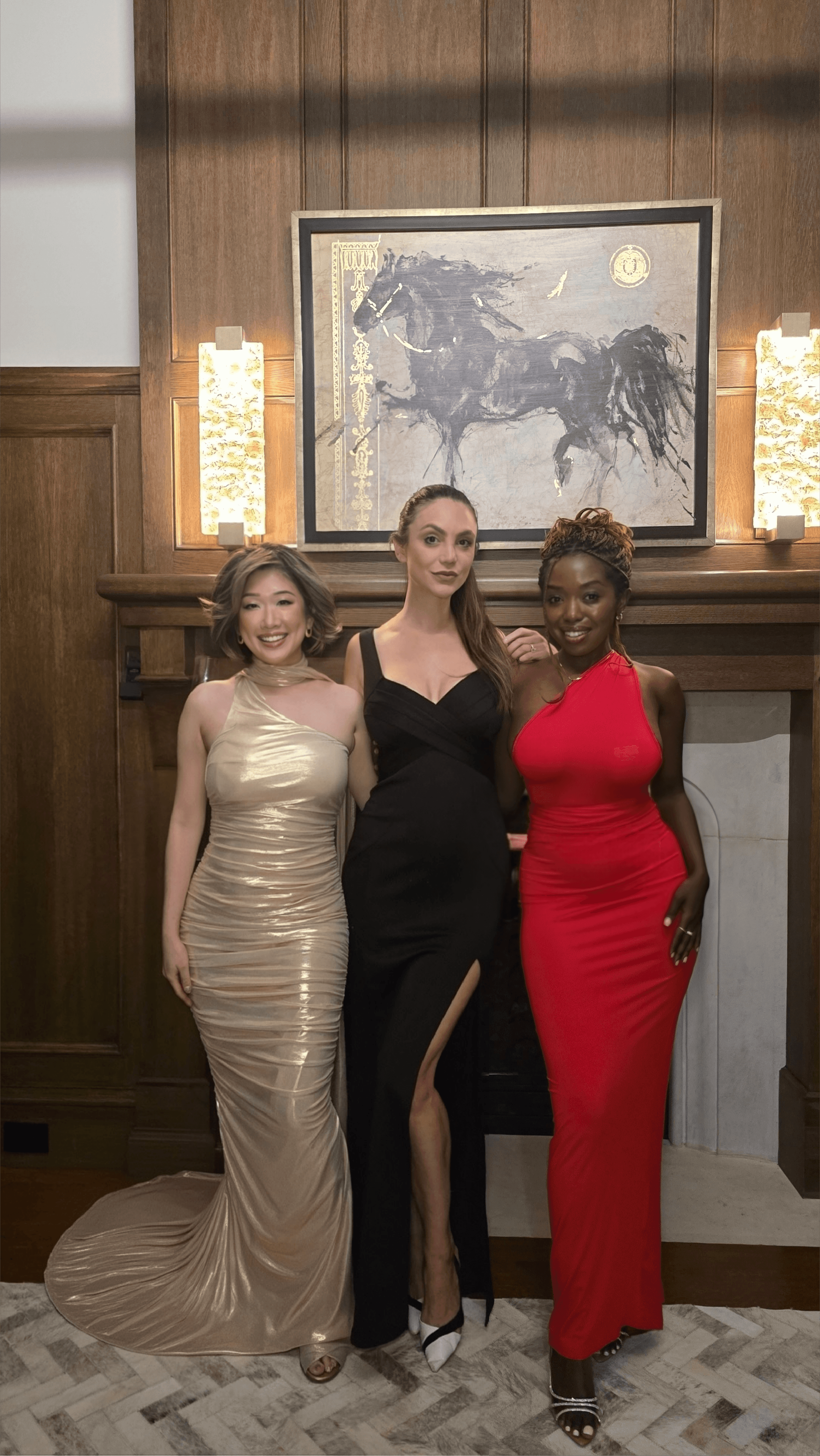 Betty Lam, Ashley Hassard & Janviere Mukama (@glamfriends.to) pose by the grand fireplace in the wood-paneled den at 40 Golf Ave.