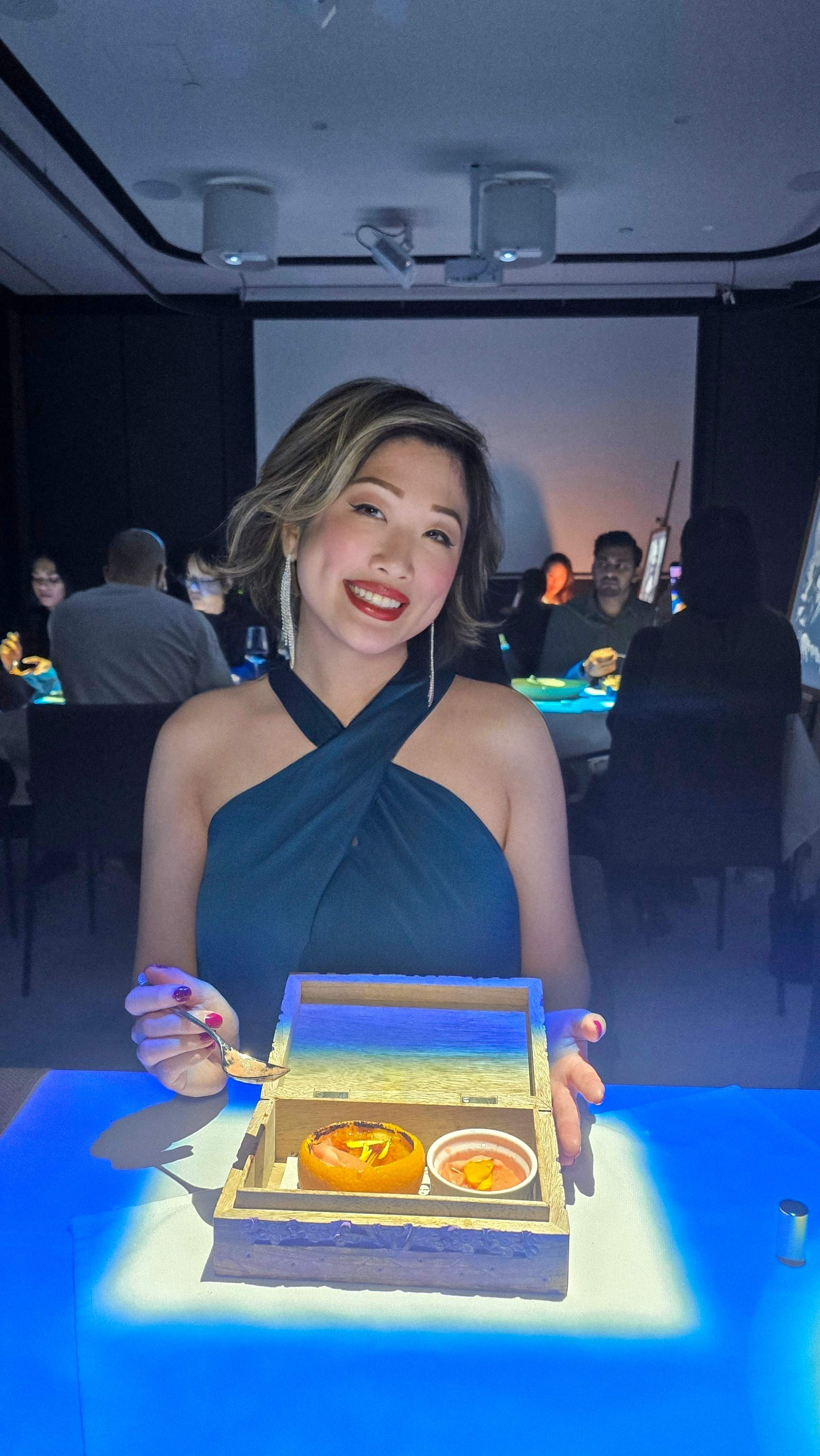 The Dalí-inspired Orange Crème Brûlée dessert course in a box at 7 Paintings, an immersive dining show in Toronto