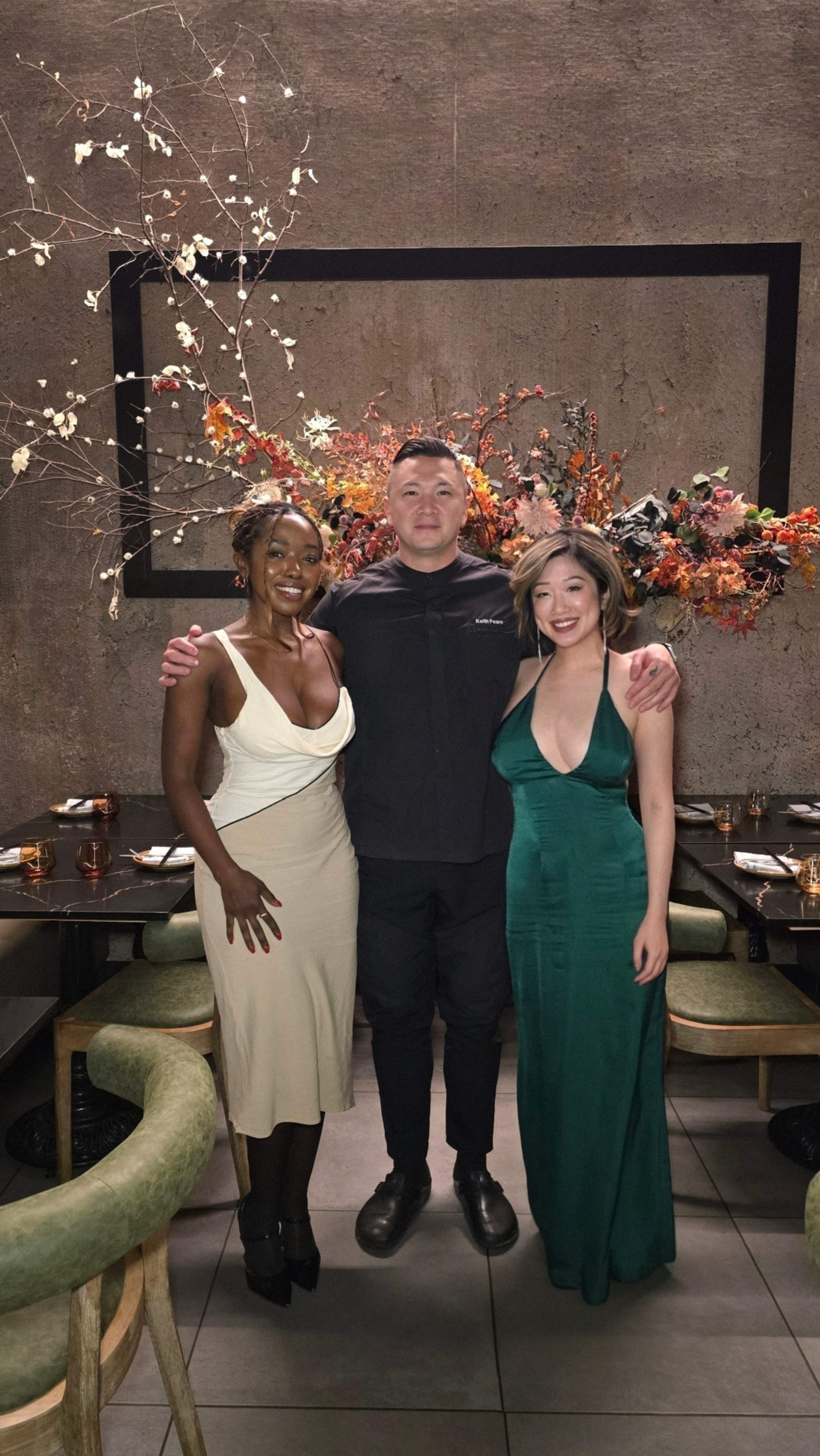 Chef Keith Pears posing with guests Janviere & and Betty Lam front of a floral installation at his Markham restaurant.