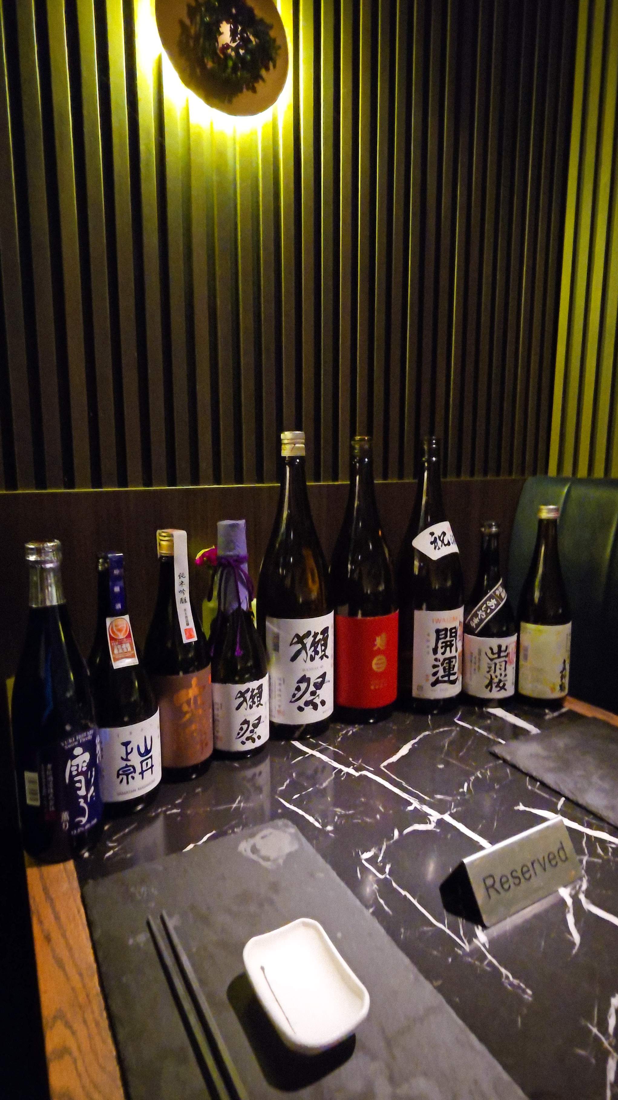 The premium 9-sake pairing flight at Flame Sushi Toronto, featuring ultra-premium Dassai 23. A perfect addition to the 12-course Holiday 