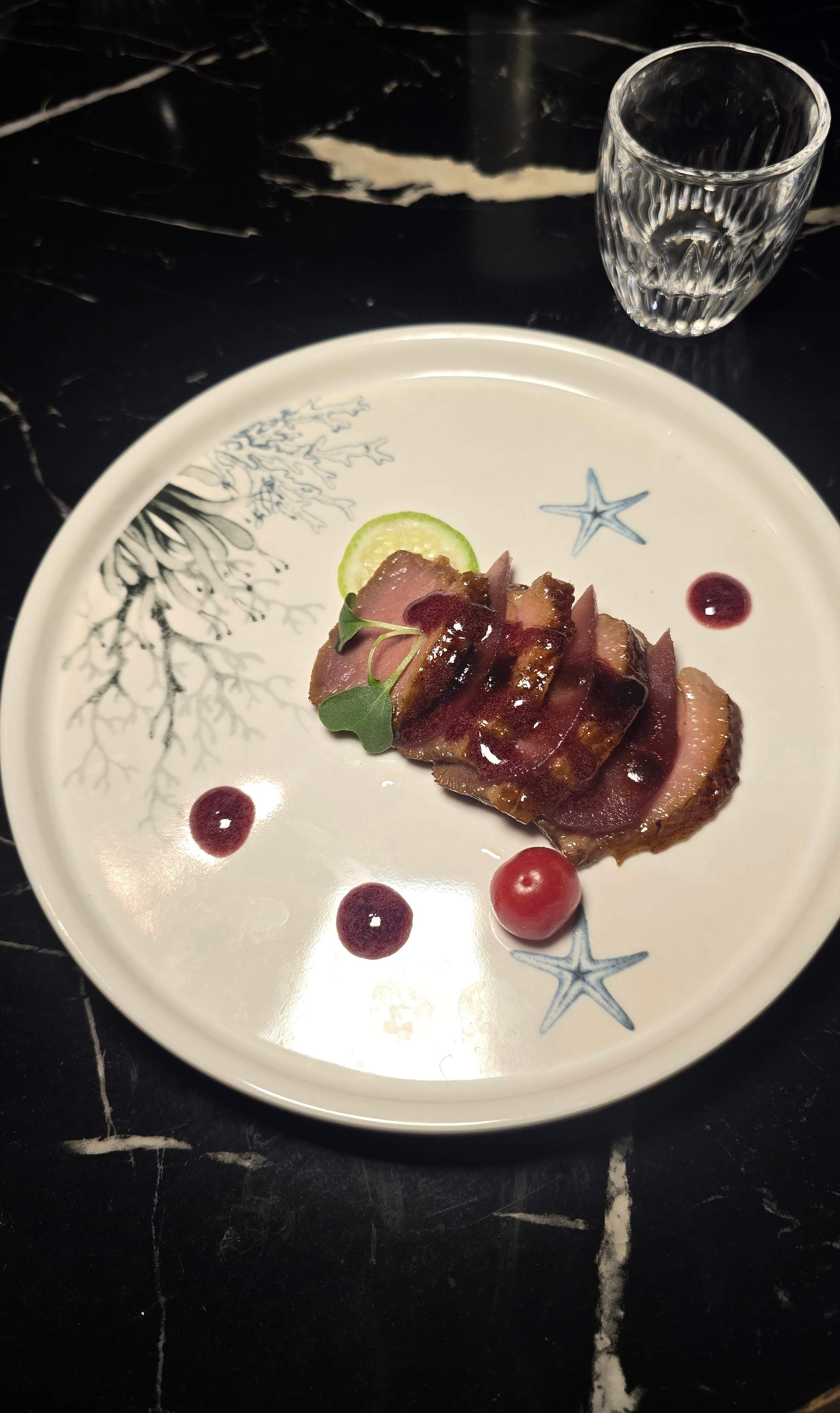 The savoury Duck Breast course with berry reduction, served as a main dish during the 12-course Holiday Tasting Menu at Flame Sushi on Queen