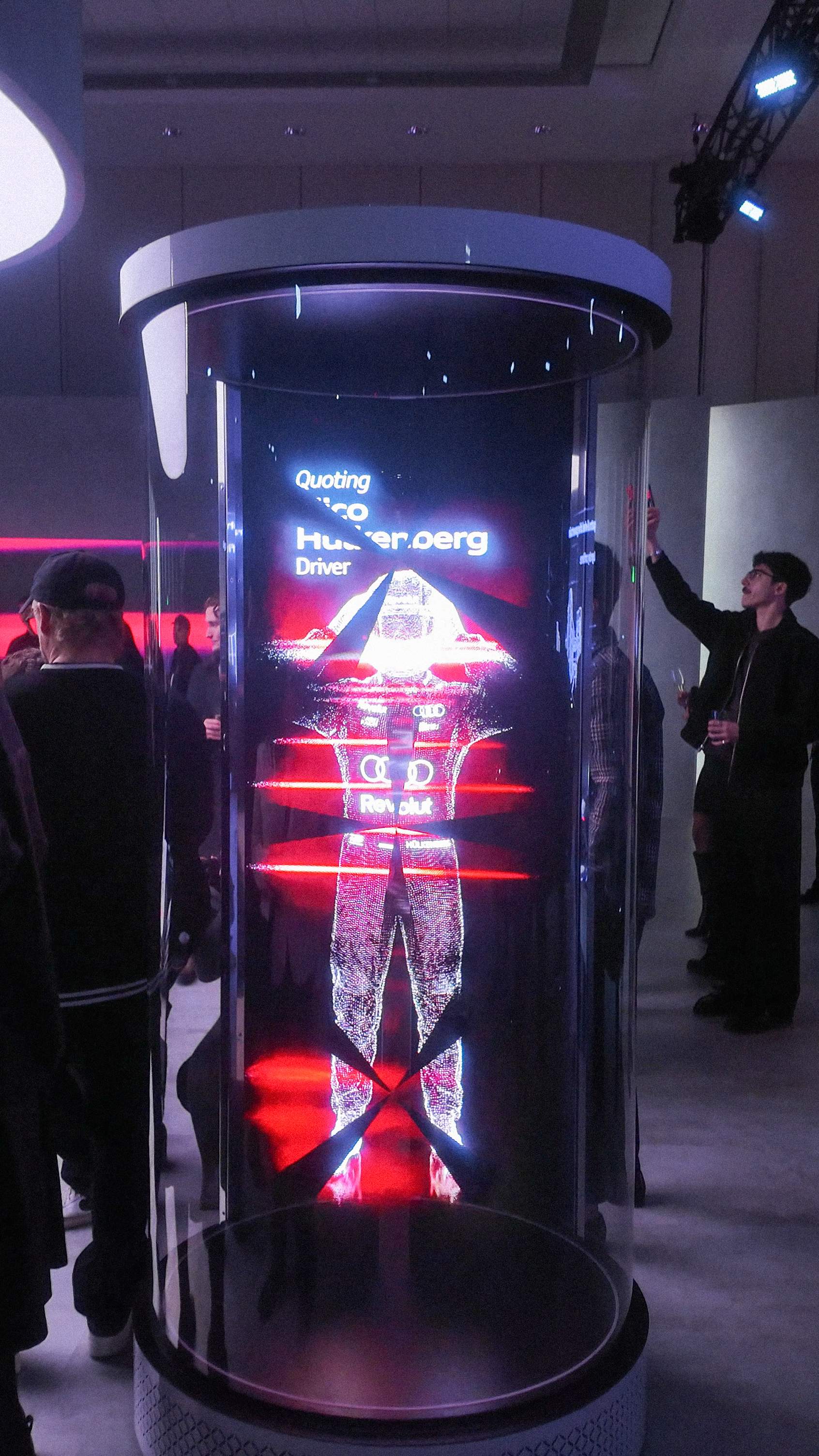 Futuristic,  digital hologram of Formula 1 driver Nico Hülkenberg displayed in glass cylinder at Audi Haus Canadian AutoShow exhibit