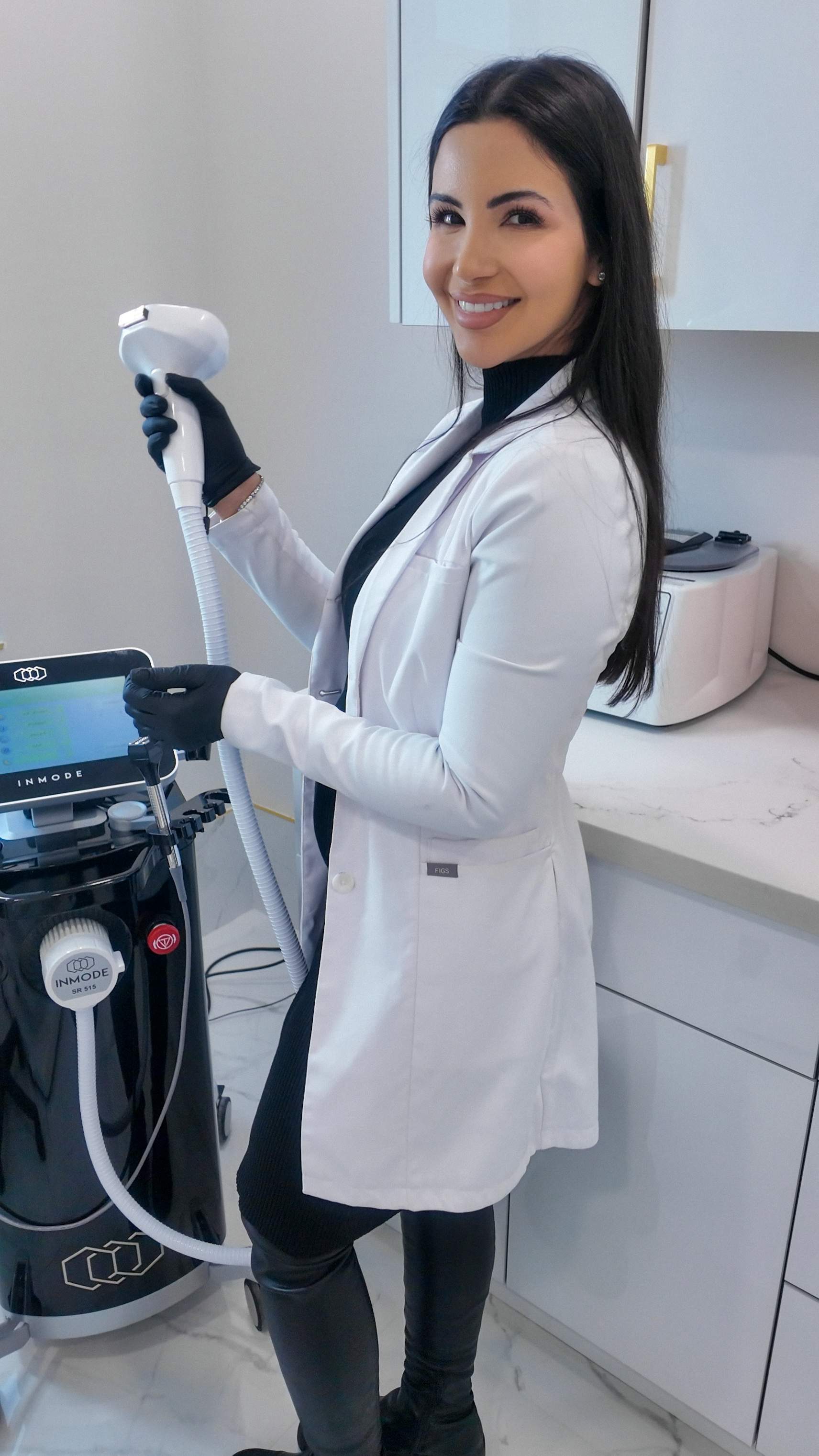Nurse Kayla at Genectables Cosmetic Clinic holding the Lumecca IPL handpiece used for reversing sun damage and treating dark spots.