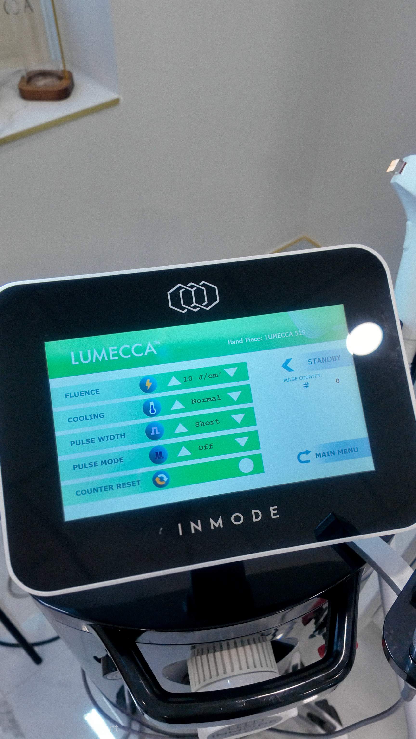 Close up of the InMode Lumecca IPL machine screen showing medical grade settings for treating deep hyperpigmentation.
