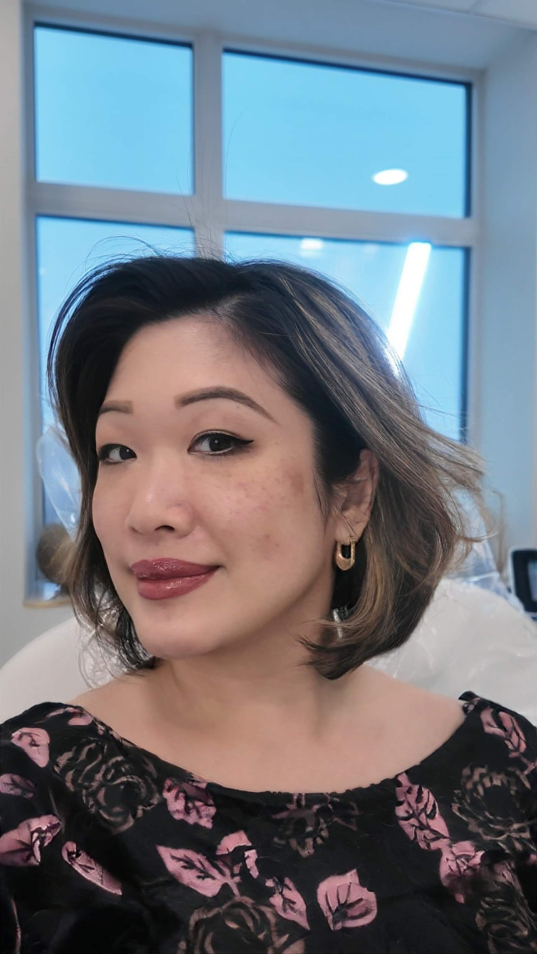 Beauty blogger sitting in a med spa chair at Genectables Cosmetic Clinic preparing for an IPL photofacial