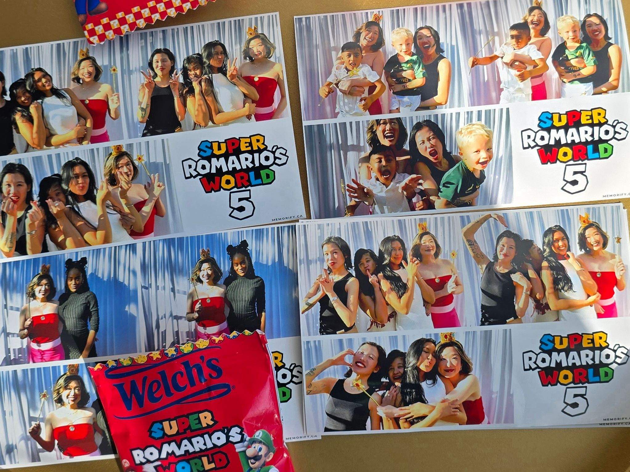 Custom Super Mario themed party favors and photo booth strips displayed on a golden tray.