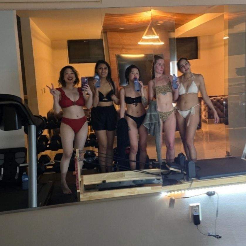 Indoor gym with mirror. Five girls pose in mirror selfie after the sauna.