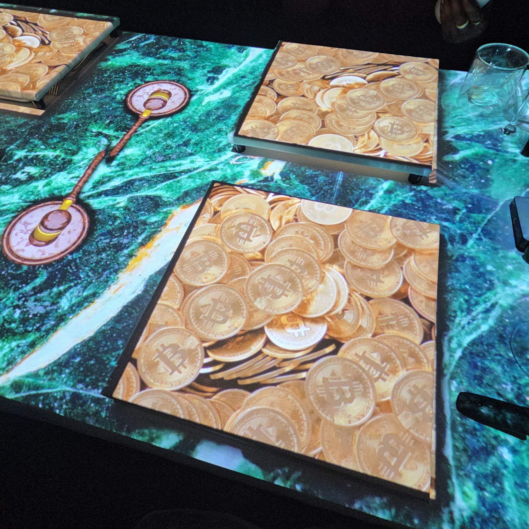 3D projection mapping on the dining table during the 7 Paintings immersive show in Toronto, showing gold coins