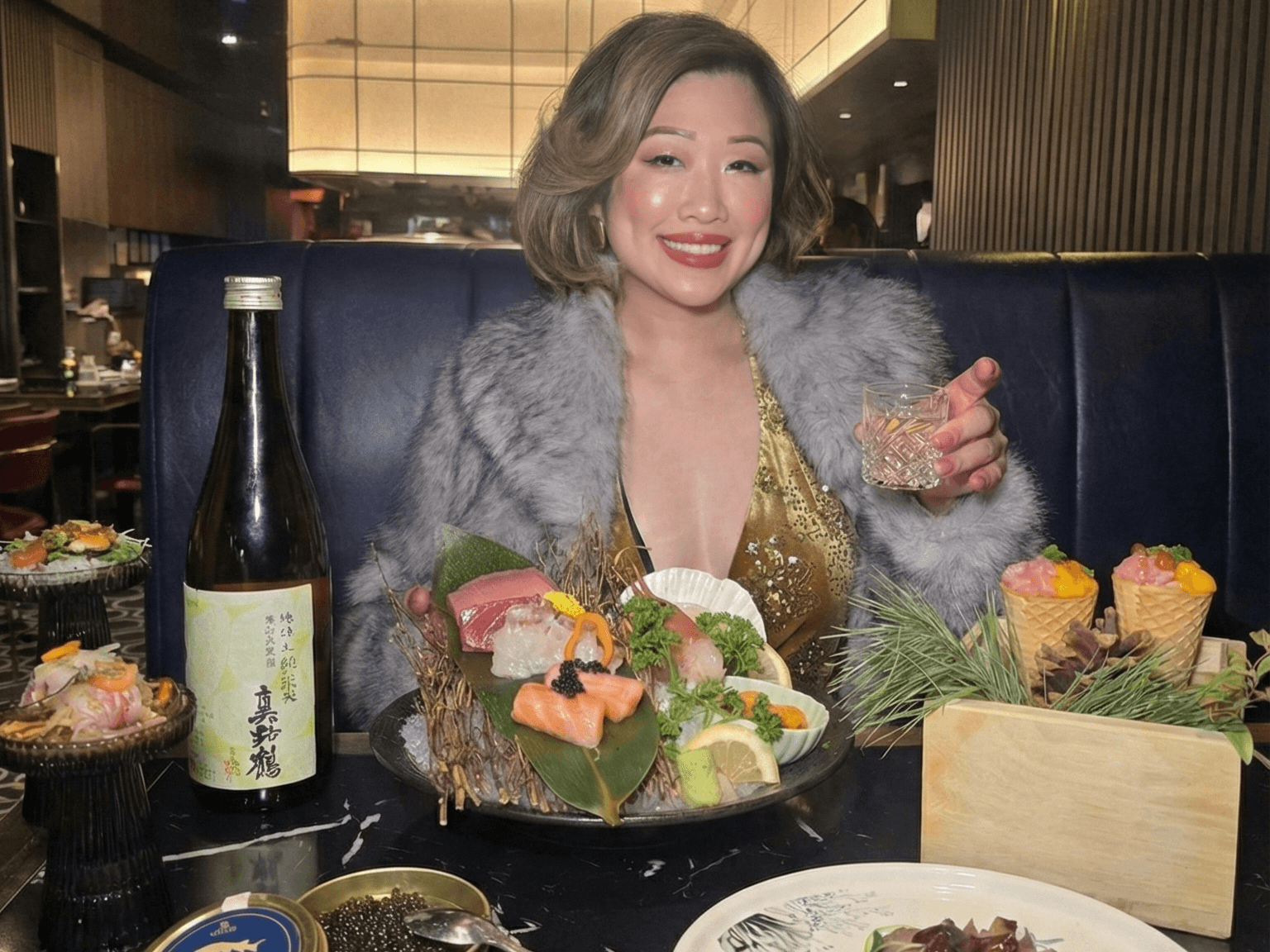 Betty Lam enjoying the 12-course Holiday Tasting Menu at Flame Sushi Toronto. Featuring Sashimi, Caviar, Duck Breast, and the 9-Sake Pairing