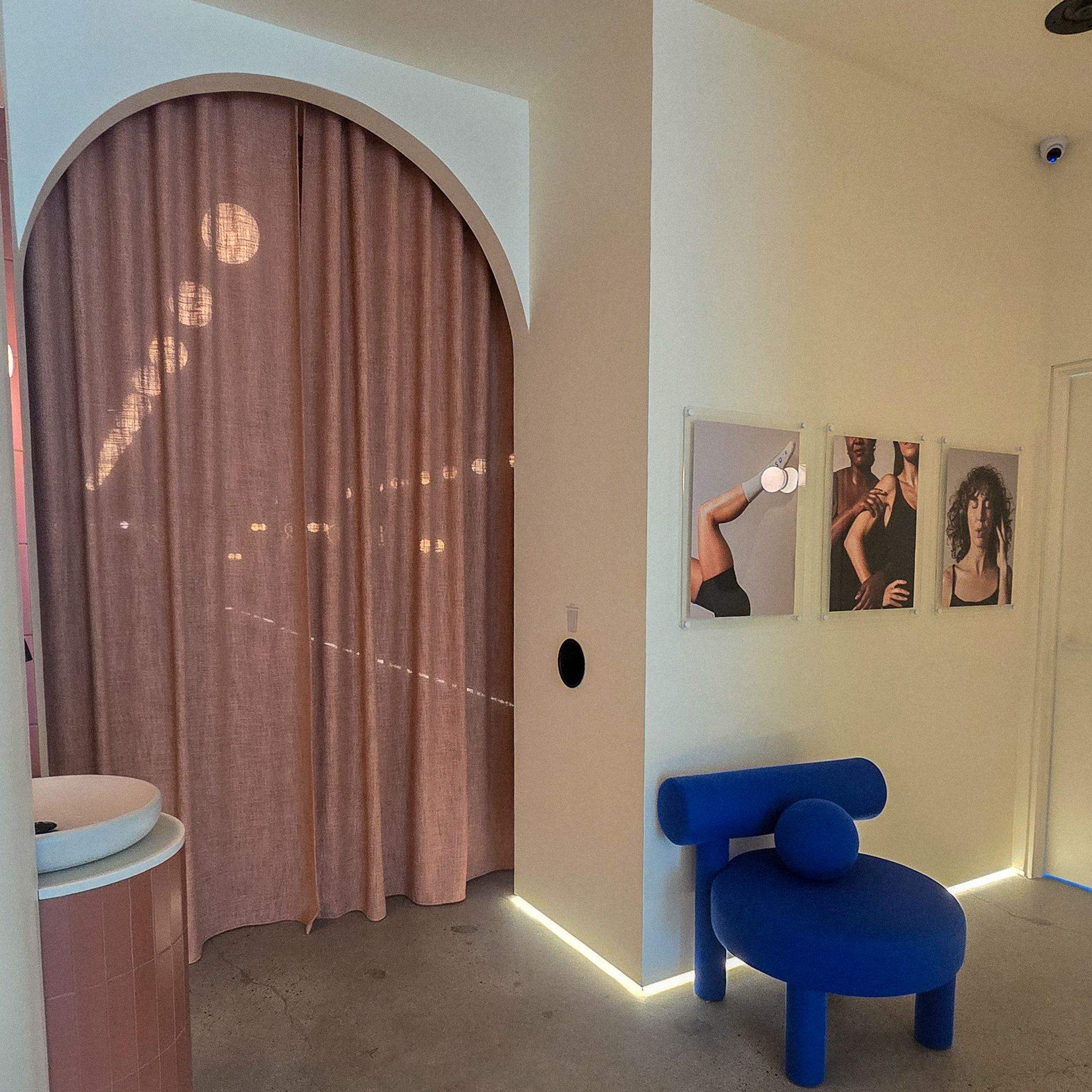 LSD°R Summerhill Toronto studio entryway with arched curtain doorway cobalt blue chair and editorial wellness space design
