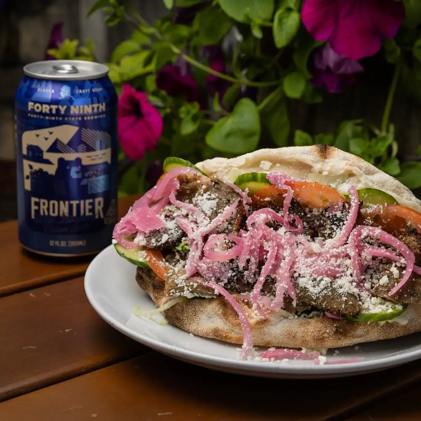 A Frontier Blueberry soda and a massive sandwich from 49th State Brewing at The Rail.