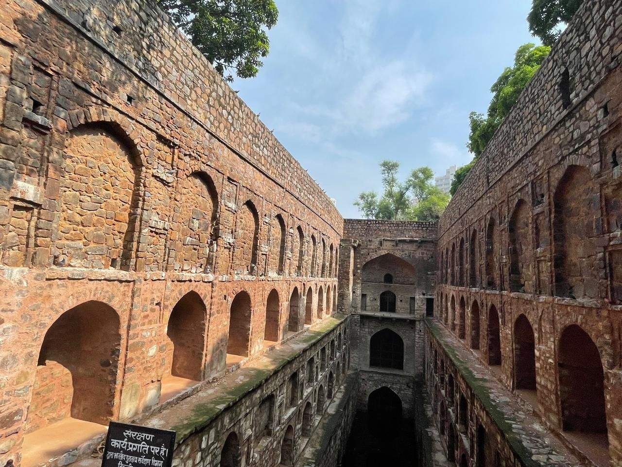 View down into the Agrasen ki Baoli stepwell in Delhi, showing multiple levels of stone archways.